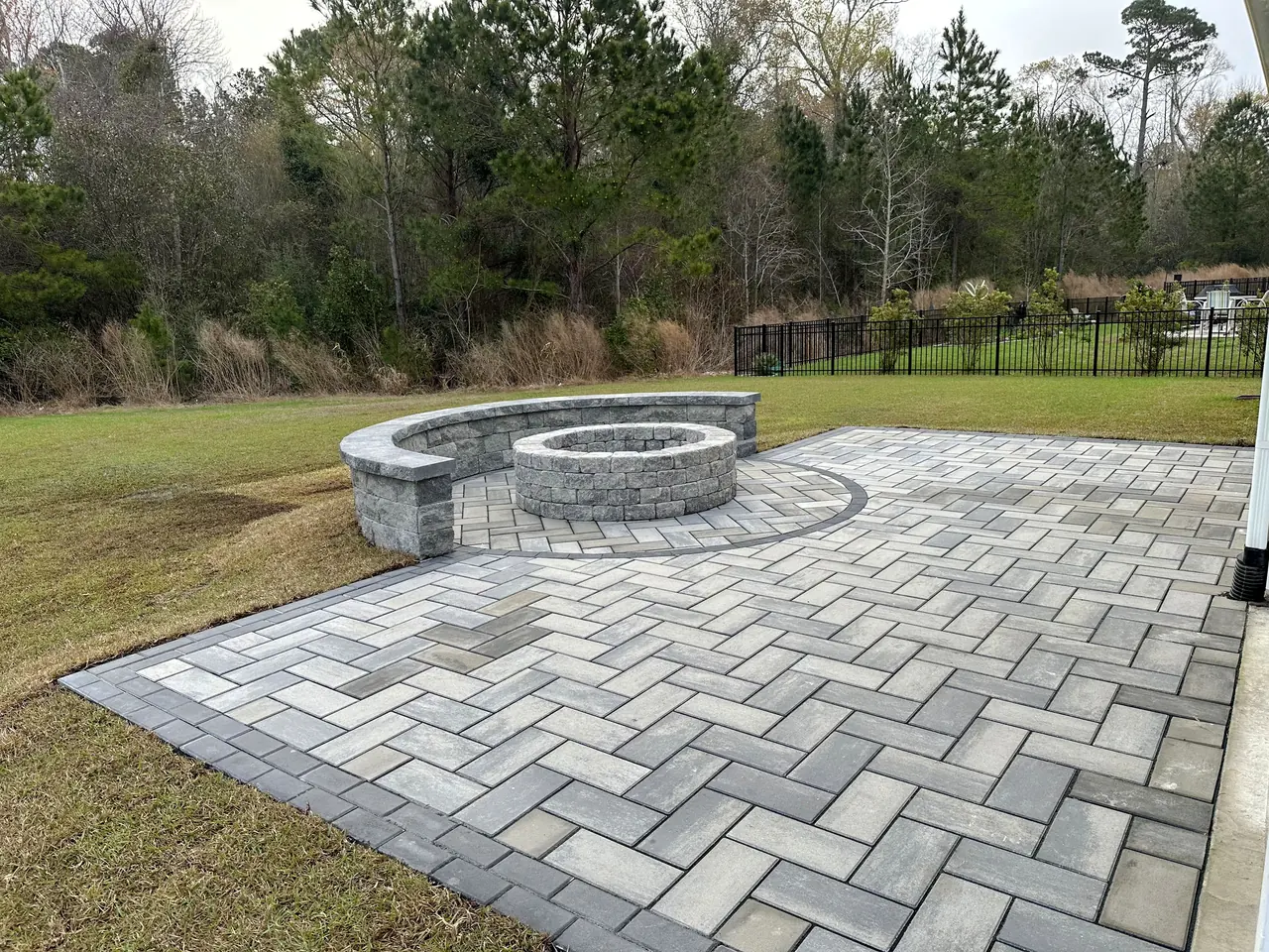Paver patio with a built-in fire pit, tight joints and clean edges.